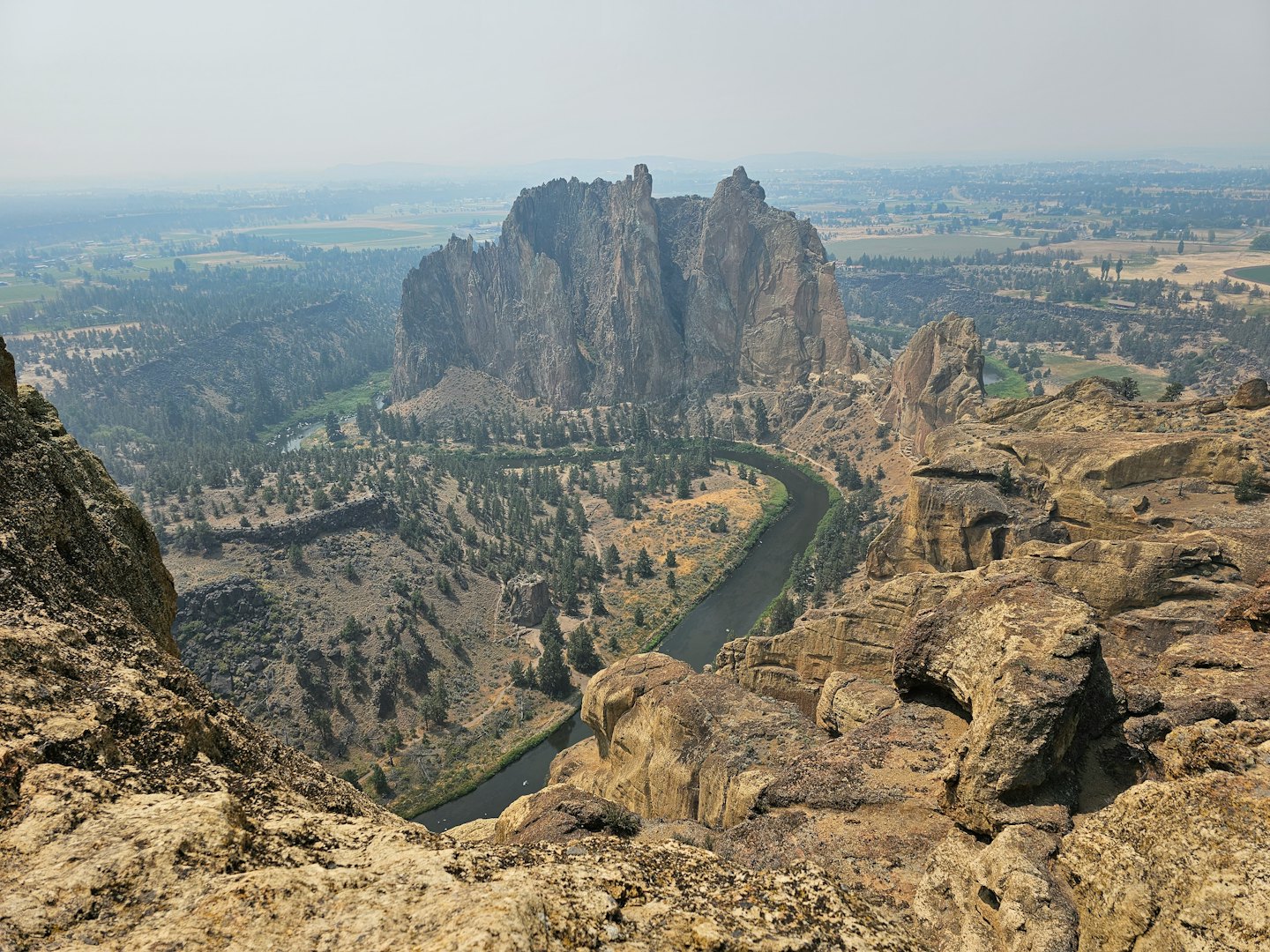 A winding river flows through a deep canyon with rocky walls.